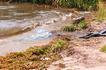 Sand beach and polluted water