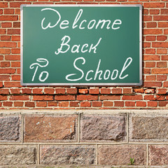 Education theme. Ancient brick wall with Welcom back to school t