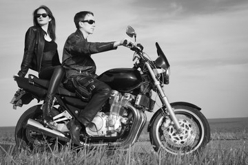 Active couple riding on the motorbike