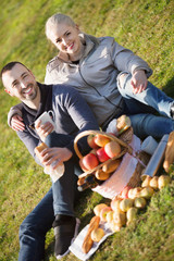 Loving cheerful  couple chatting as having picnic