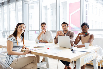 Business people sitting and listening at conference in office