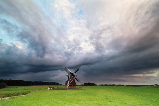dark stormy clouds over windmill