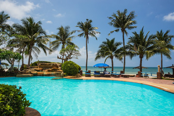 Fototapeta na wymiar Pool and palms on sea shore. Thailand, Koh Chang,