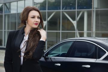 Fototapeta na wymiar Business woman standing in the street background car