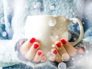 Tea in a cup. A girl holding a cup of tea