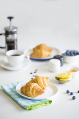 Croissants and coffee on table