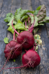 Three beetroot on the wooden table