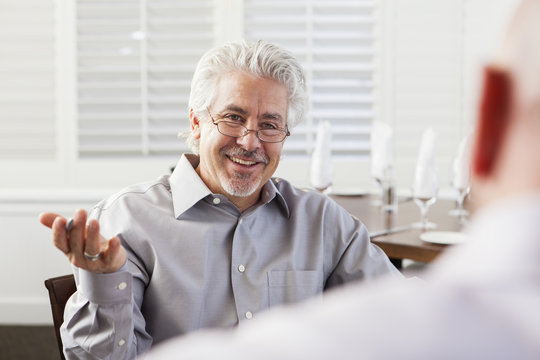 Businessmen talking in cafe