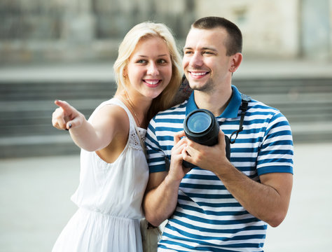 Couple walking with camera