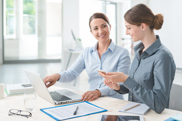 Business women working together on a laptop