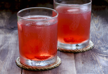 Lemonade with strawberries on a wooden table
