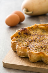 Homemade pumpkin pie on wooden background

