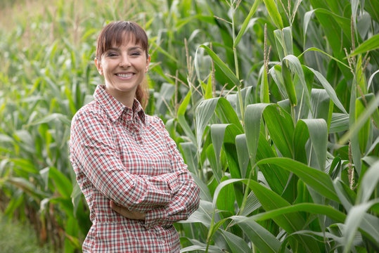 Smiling farmer posing in the corn field