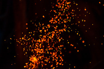 Christmas Glitter Lights Defocused Background. Sparks from the flame
