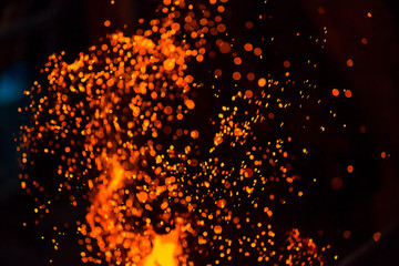 Christmas Glitter Lights Defocused Background. Sparks from the flame