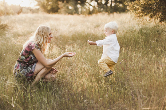 Mother and son playing in field