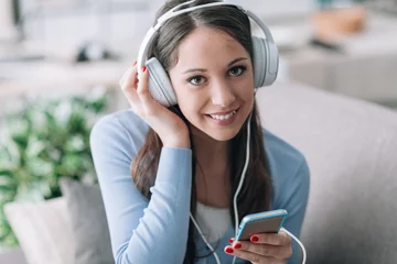 Foto op Plexiglas Smiling woman listening music © stokkete
