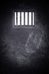 Fototapeta premium prison with light and shadow through a barred window background. high contrast and over light 