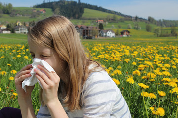 young girl is blowing her nose, allergy