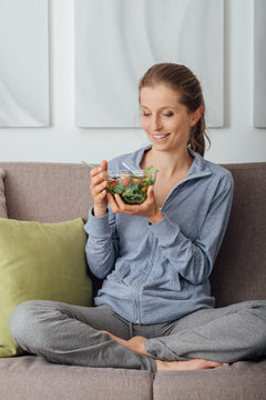 Young woman having lunch at home