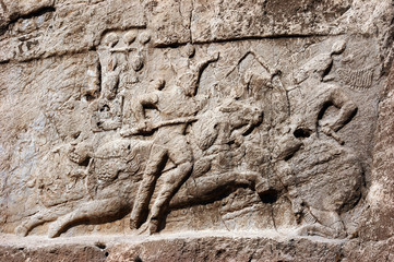 Historical relief carved between 239 - 70 AD about Victory of Bahram II, Sasanian King of Persia. Ancient monuments of Naqsh-e Rustam, rocky necropolis near Persepolis, Iran. 