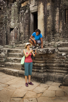 Couple visiting ancient temple, Angkor, Siem Reap, Cambodia