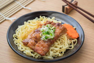 Noodles with grilled teriyaki chicken on plate