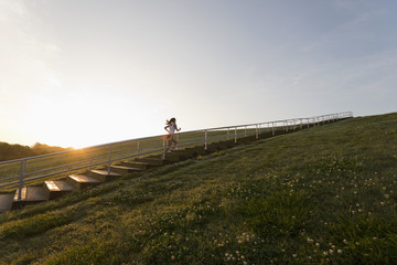 Caucasian woman running up steps