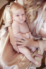 close-up portrait of baby lying on mother hand. mom and child co
