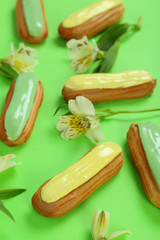 Eclairs with glaze on a paper background