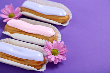 Eclairs with glaze on a paper background