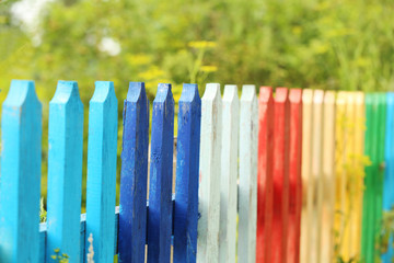 Colorful wooden fence in the garden