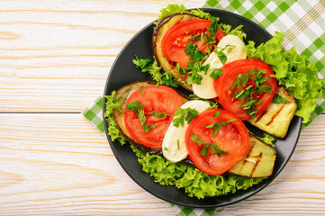 Appetizer - grilled eggplants with mozzarella and tomatoes.