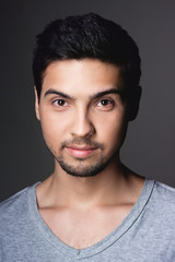 Obraz premium Portrait of a normal boy over grey background / Attractive young