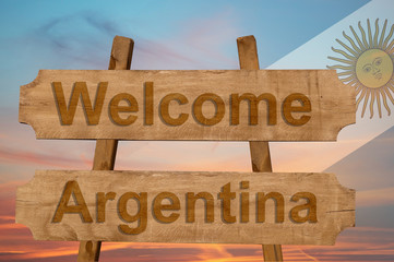 Welcome to  Argentina sing on wood background with blending national flag