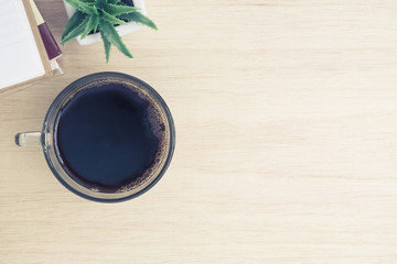 Desk above, table top view of office desk - a cup of hot coffee,