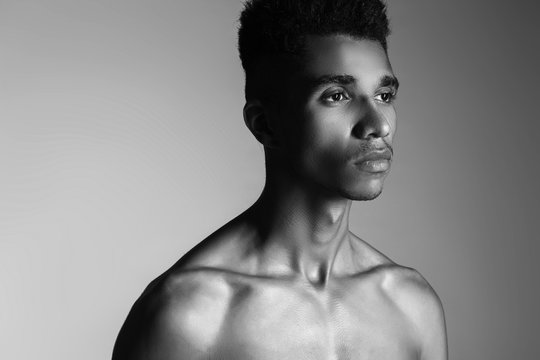 beautiful African American with a naked torso in the studio, bea