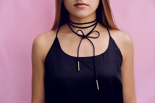 Stylish girl with black choker bow accessory.