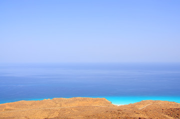 top view of the emerald sea and the sandy beach yellow. Lots of space for inscriptions. Space, air, summer background
