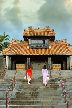 Two women walking up steps, Tu Duc's tomb, Hoi An, Vietnam