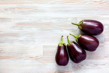 Raw Eggplants on Wood Background