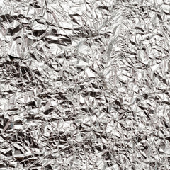 Silver crumpled foil texture background