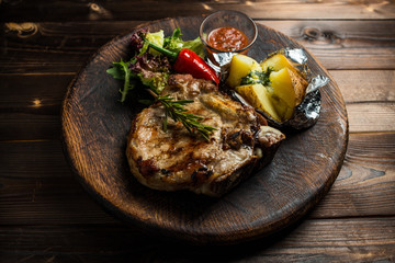 pork loin on board with vegetables gourmet