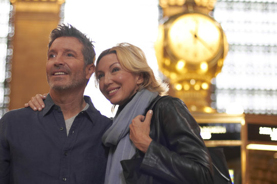 Caucasian couple hugging in Grand Central Station, New York City, New York, United States