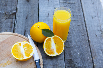 Orange juice in glass with knife.