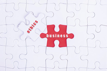 Missing white puzzle with Business, Ethics word and copyspace