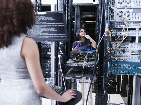Businesswomen working in server room