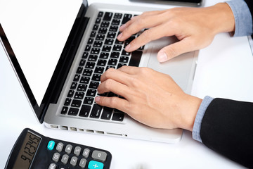 Business man hands typing on a PC or laptop keyboard