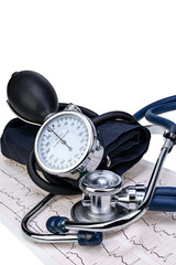 Medical stethoscope and manometer on cardiogram chart isolated closeup