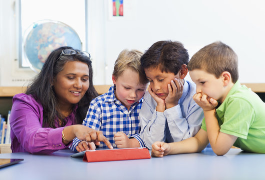 Teacher and students using digital tablet